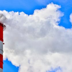 industrial smoke from chimney on blue sky